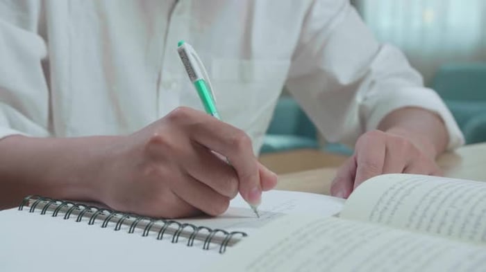 Person Writes in Notebook with Book, People Stock Footage ft. studying ...