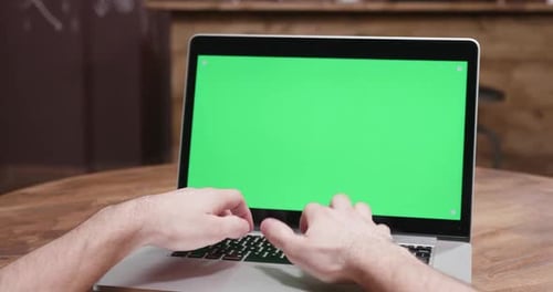 POV Parallax Footage of Male Hands Typing Fast on a Computer with Green Screen