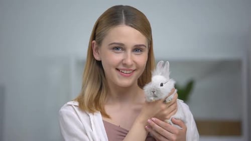 Young Woman Holding Cute White Rabbit