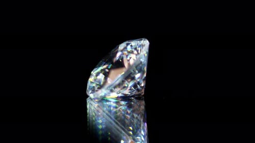Rotating Faceted Diamond Reflects on Black Background