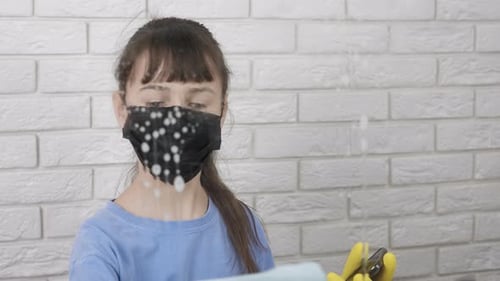 Child Wipes Surface While Using Cell Phone