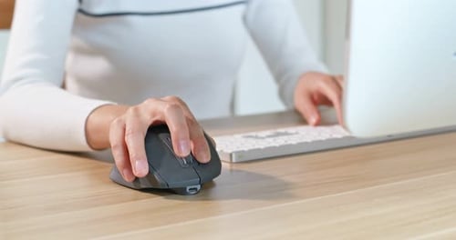 Woman Using Mouse and Keyboard at Computer