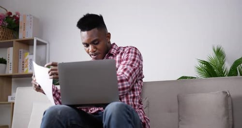 Man Working on Laptop at Home