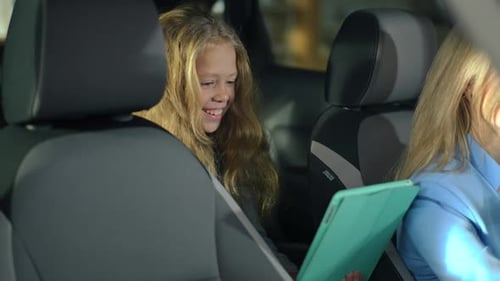Girl Uses Tablet in Car Back Seat