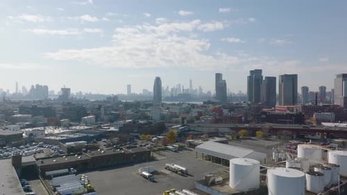 Aerial Shot Industrial Zone with Large Tanks Elevated Multilane Highway and Apartment Buildings