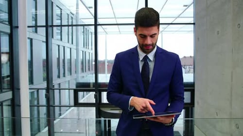 Businessman Using Tablet in Modern Office Building