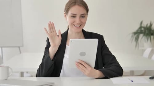 Woman Waving During Tablet Computer Video Call
