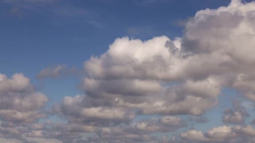 Majestic White Clouds Dancing Across a Blue Sky