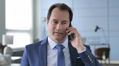 Man in Suit Talking on Phone