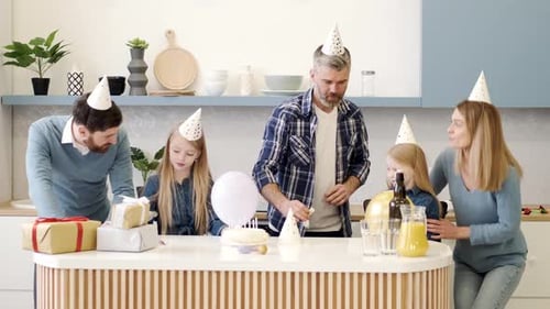 Family Celebrates Birthday at Home with Cake and Gifts