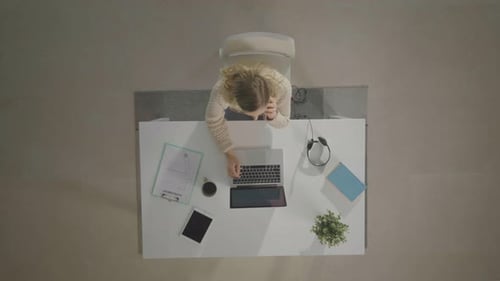 Woman Working at Laptop at Desk Overhead