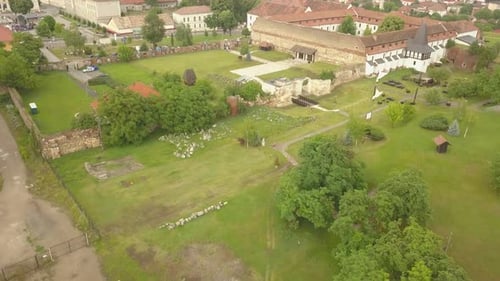 Aerial Establishing Shot (Far Away) of Citadel Walls/ruins with Orthodox Roofs and Trees visible in