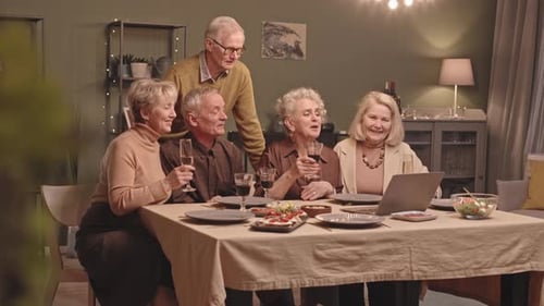 Seniors Video Calling and Toasting at Dinner