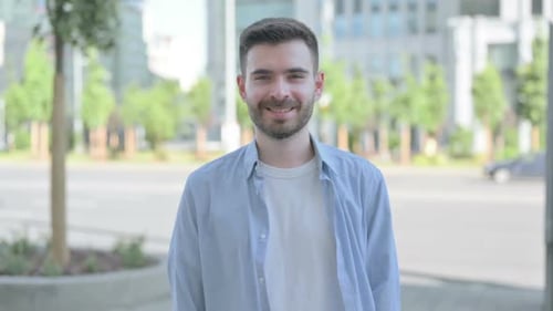Bearded Young Man Smiling in Urban Environment