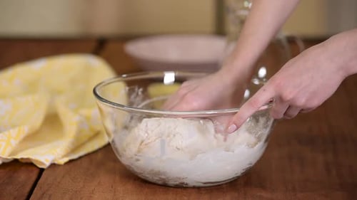 Female Preparing and Knead the Dough in Bowl