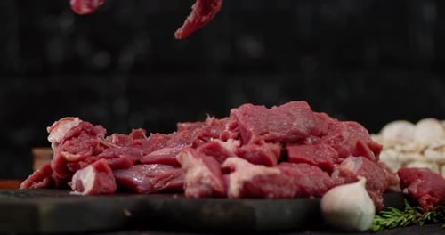 Sliced Raw Beef on a Cutting Board.