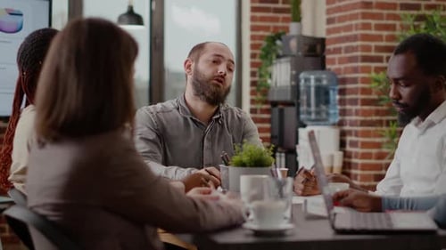 Close Up of Employee Meeting with Coworkers for Project Planning