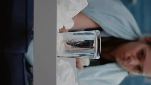 Vertical Video Close Up of Woman Putting Effervescent Medicament in Water