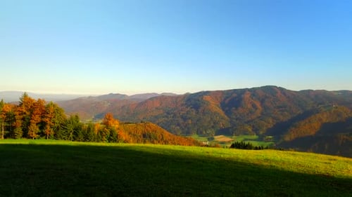Autumn Mountain Vista with Colorful Foliage and Green Meadow