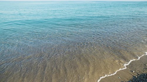 Beach with Sea and Calm Waves in Summer in Sicily
