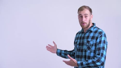 Man Points to Left with Thumbs Up