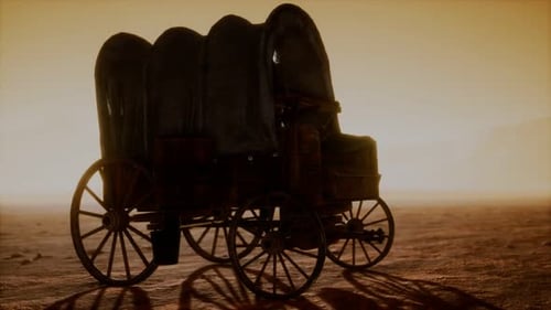 Vagón retro cubierto de lona en el desierto al atardecer