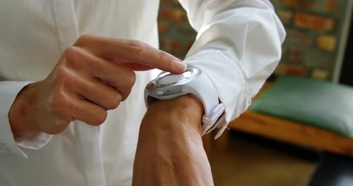 Female executive using smartwatch in office 4k