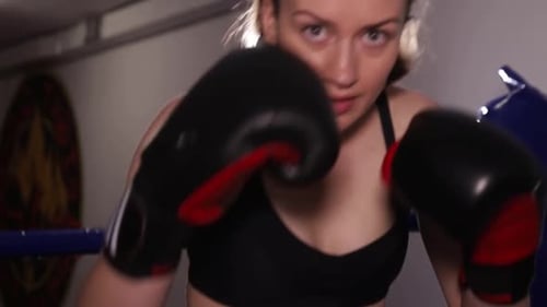 Woman Boxer Practicing Punches in Boxing Ring