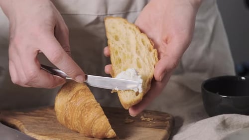 Preparing Breakfast Croissant with Cream Cheese