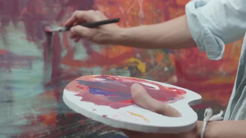 Hand Holding Paint Brush And Painting Art