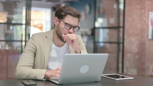 Man Working On Computer At Desk Indoors