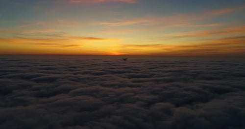 Majestic Aerial View Over Clouds at Sunset