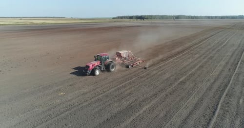 Countryside and Agriculture, Farm Tractors Plow the Earth in Field, Dust in the Field, View From