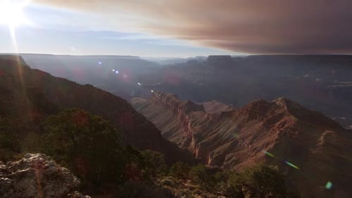 Panning view with Sun flares over the South Rim of the Grand Canyon