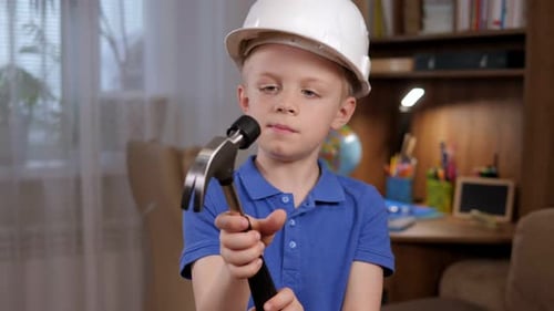 Child in Hard Hat Holding a Hammer