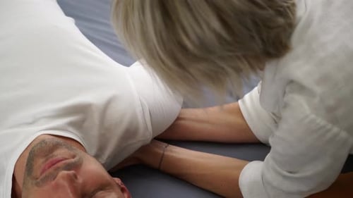 Man Receiving Massage Therapy at Home