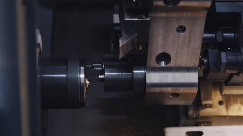 Closeup Automated Cnc Turning Lathe Machine Cutting Metal Part at Factory