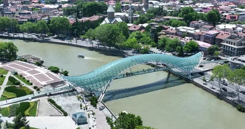 Aerial view of Tbilisi city central park and Bridge of Peace. Beautiful cityscape of old Tbilisi at