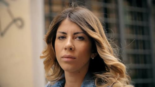 Woman in Denim Jacket with Wavy Blonde Hair