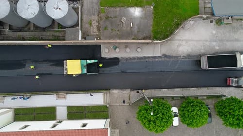 Aerial View of Paver Laying Asphalt on Road