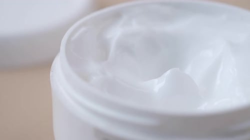 Close Up of Beauty Cream in a White Container