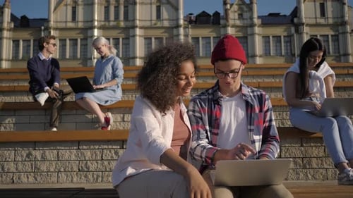 Multiethnic Friends Man and Woman Using Laptop on University Campus