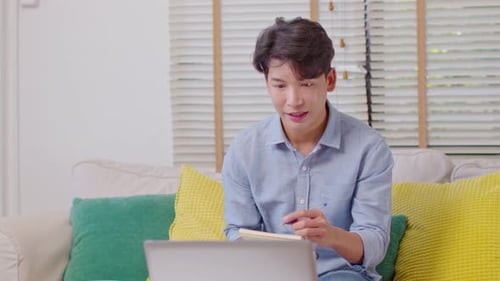 Young Adult Working From Home on Laptop