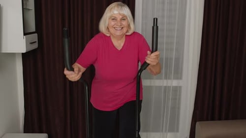 Senior Woman Exercises on Elliptical at Home