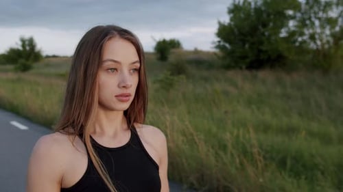 Woman Posing Stylishly on Rural Road