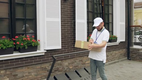 Delivery Man Walking with Package in Urban Setting