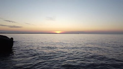 Beautiful vibrant high contrast sunset low altitude flyover over the Karosta war port concrete coast