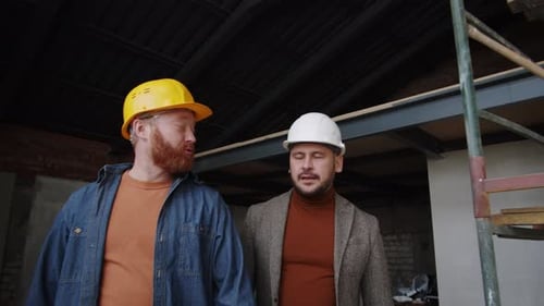 Construction Workers Inspecting New Building Site