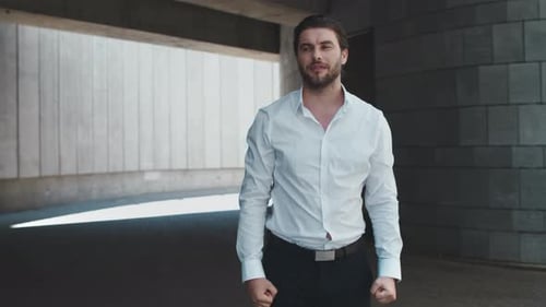 Business Man Celebrating Success Outdoors. Male Employee Jumping in Air