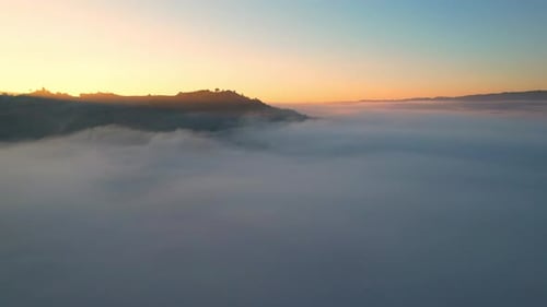 4K Drone Flying through the clouds at dusk or dawn. Aerial top cloudscape